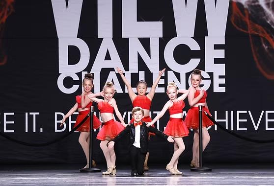 Danscott tap dancers in red costumes performing on stage