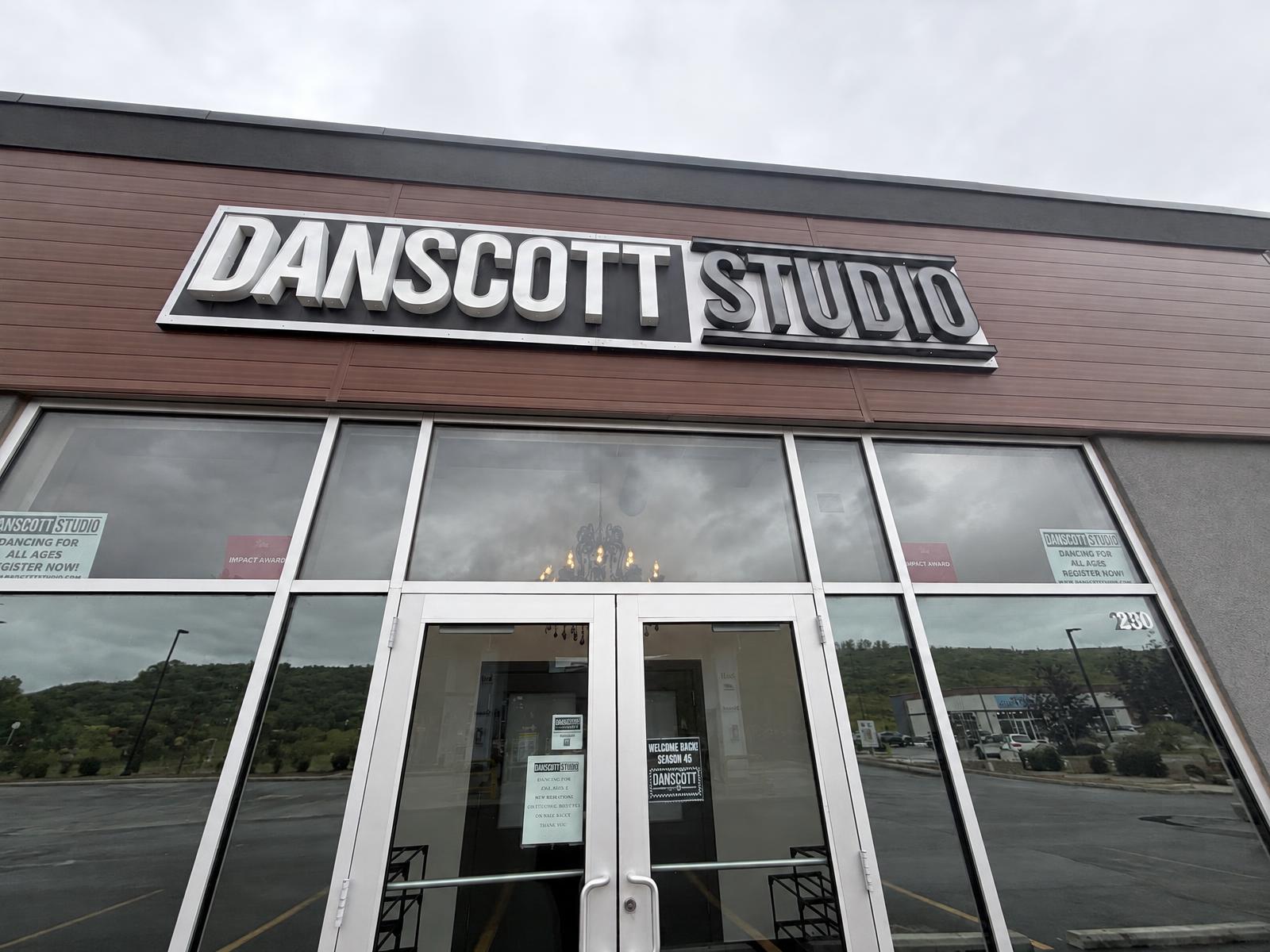 Danscott Studio storefront with the studio sign above glass front doors