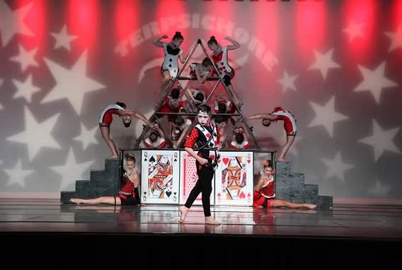Danscott acro dancers forming a pyramid on stage in a playing card routine